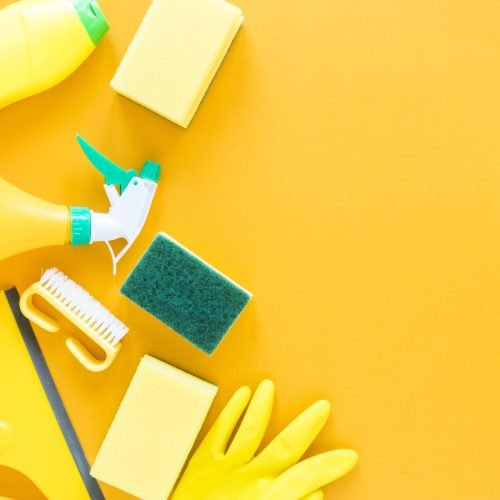 flat-lay-frame-with-yellow-cleaning-products-background